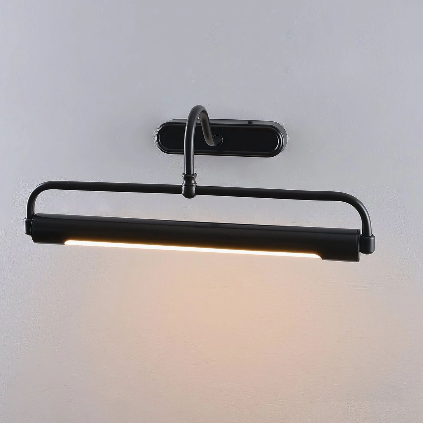 Wall sconce with brass finish gooseneck arm and oval backplate, architectural lighting detail