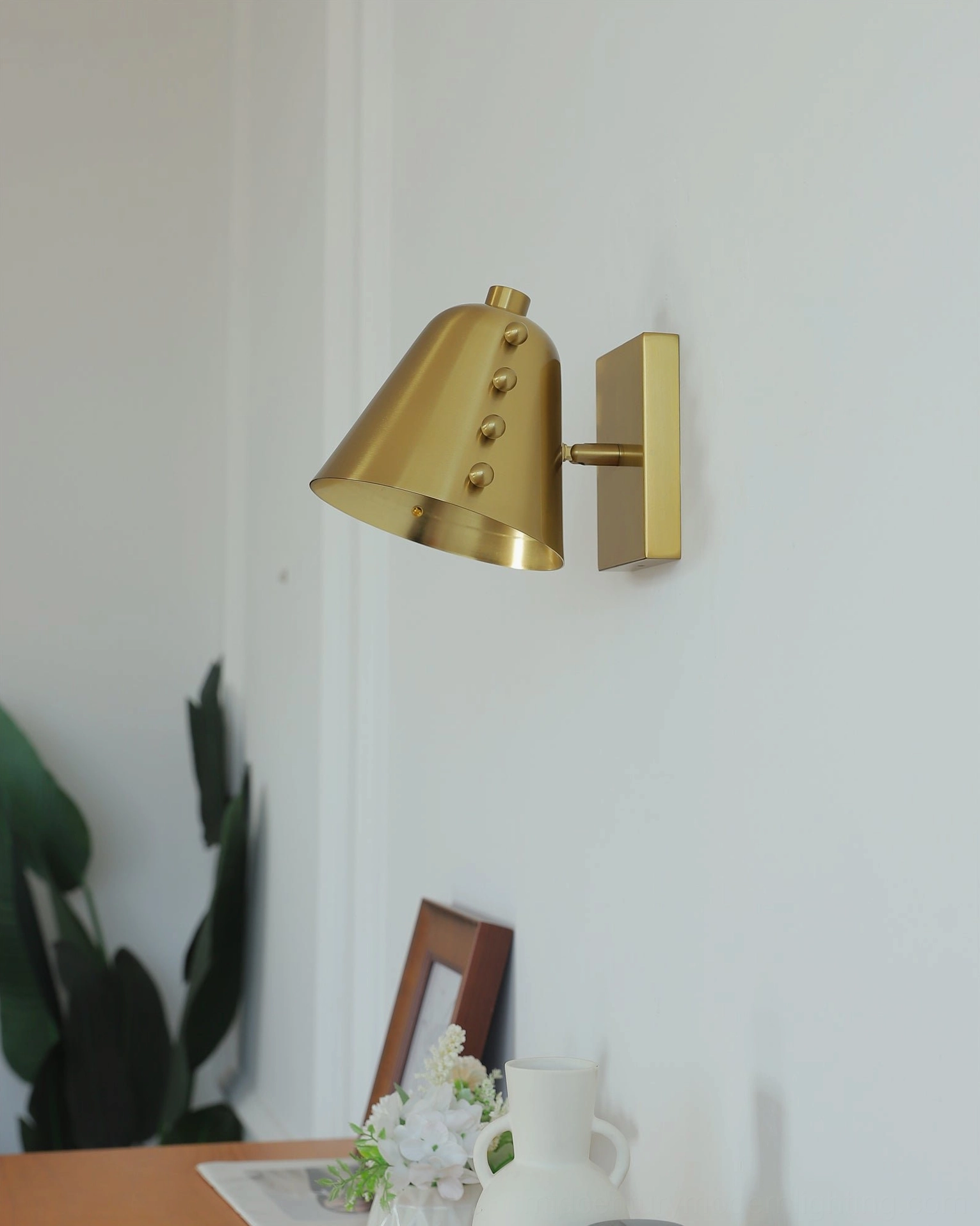 Brass wall sconce rear view showing metal mounting bracket and construction detail minimalist