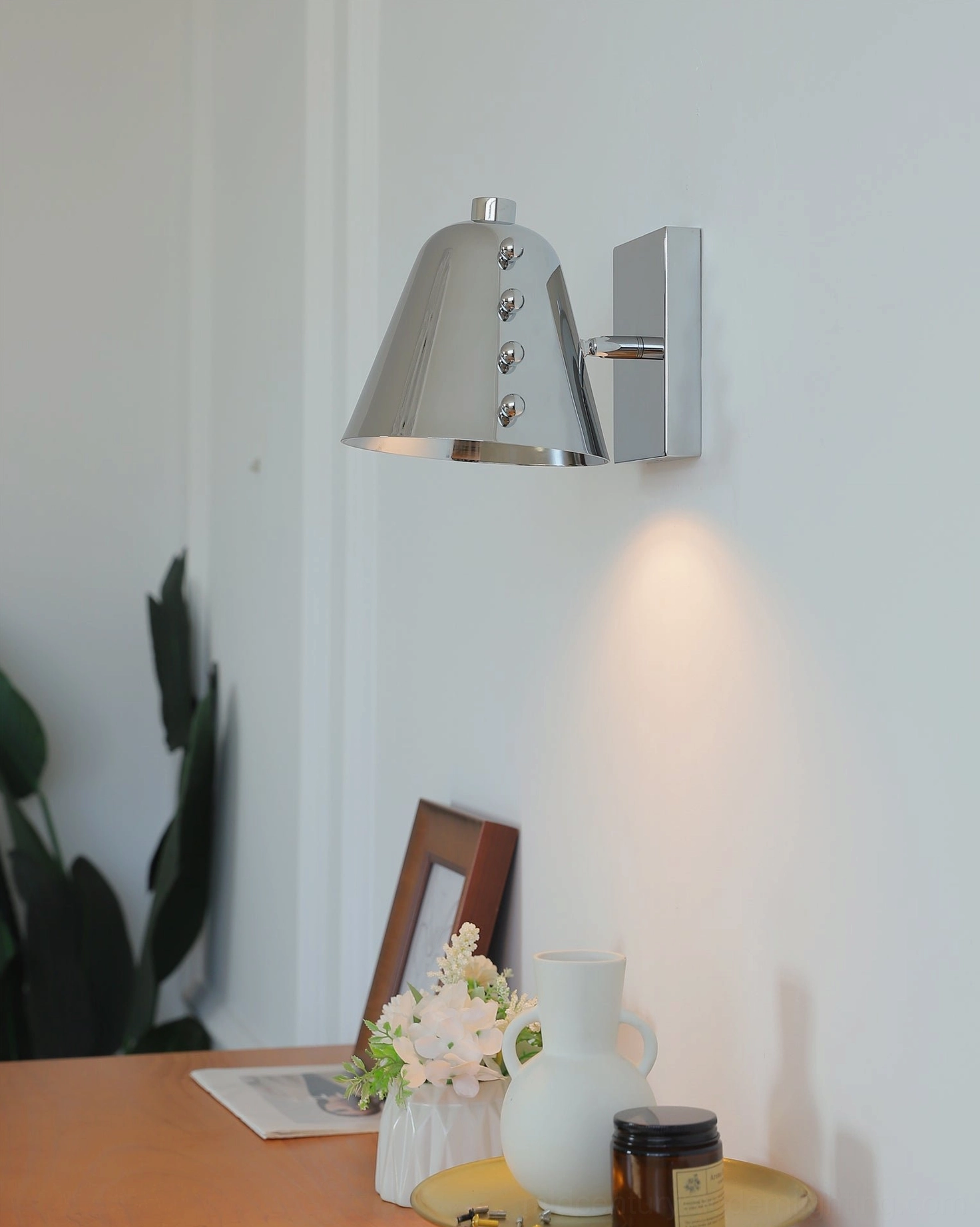 Brass gold wall sconce in Scandinavian interior with light wood furniture and neutral palette
