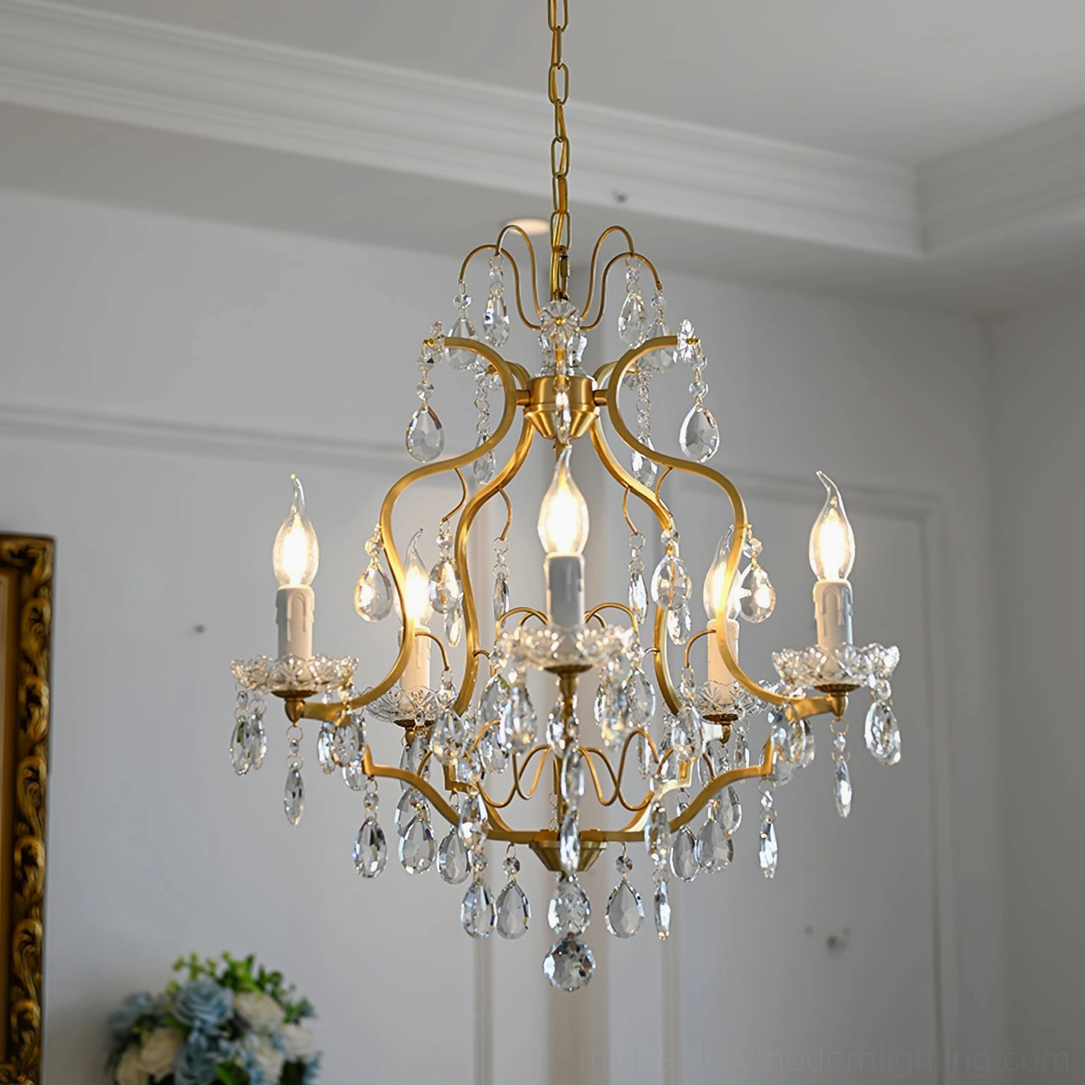 Three-quarter view of ornate brass scrollwork chandelier with abundant faceted crystal ornaments