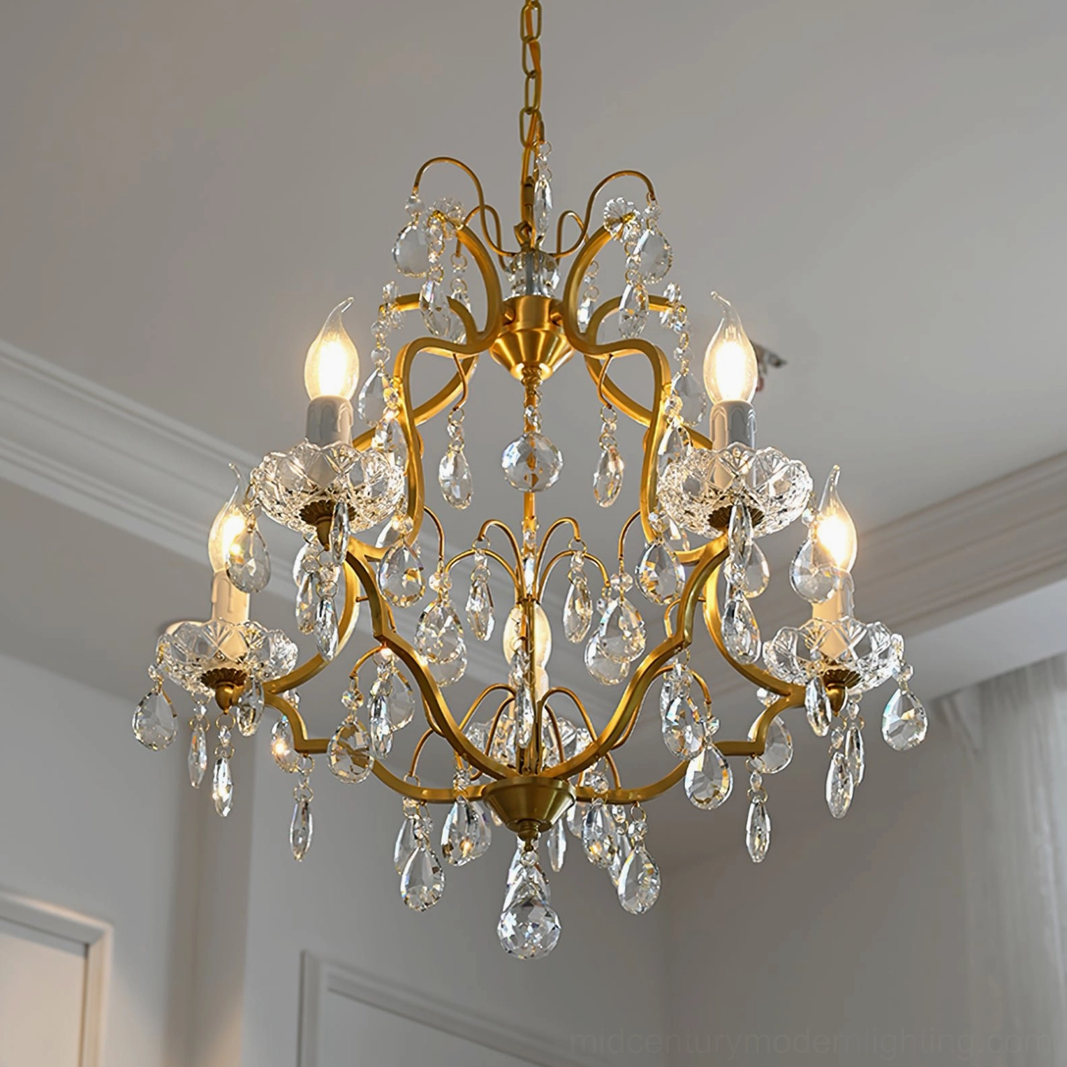Brass scrolls crystal chandelier front full view with polished finish and unlit candle bulbs