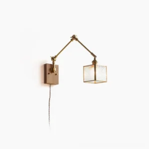 Dual-arm mid-century modern swing wall lamp with brass hardware and ribbed glass shade, front studio view