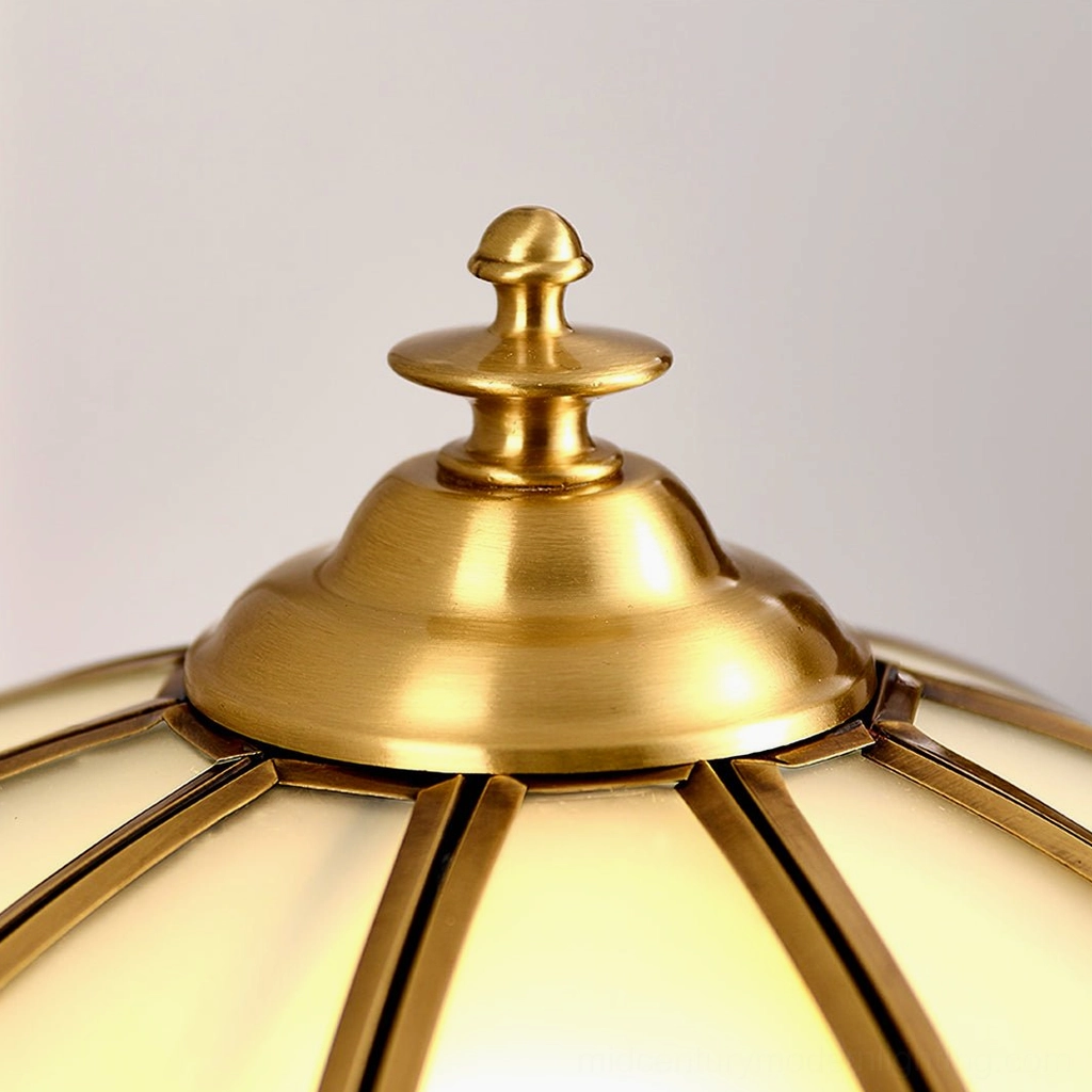 Brass table lamp styled in contemporary home office with vintage accessories and workspace
