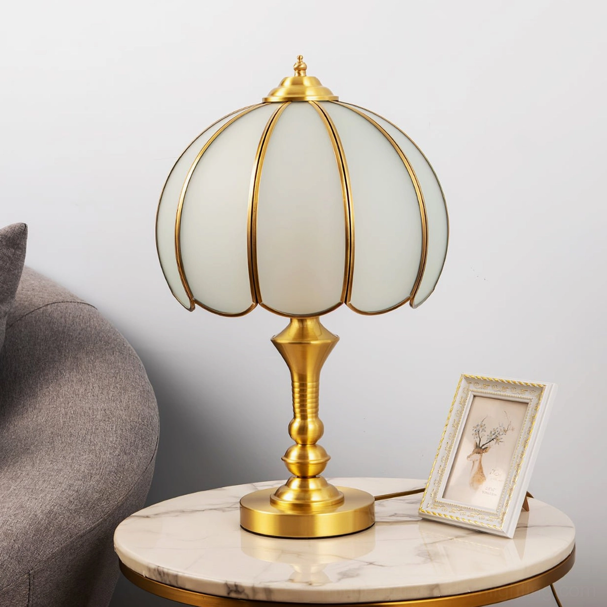 Brass table lamp with Edison bulb installed, warm vintage lighting effect in bedroom setting