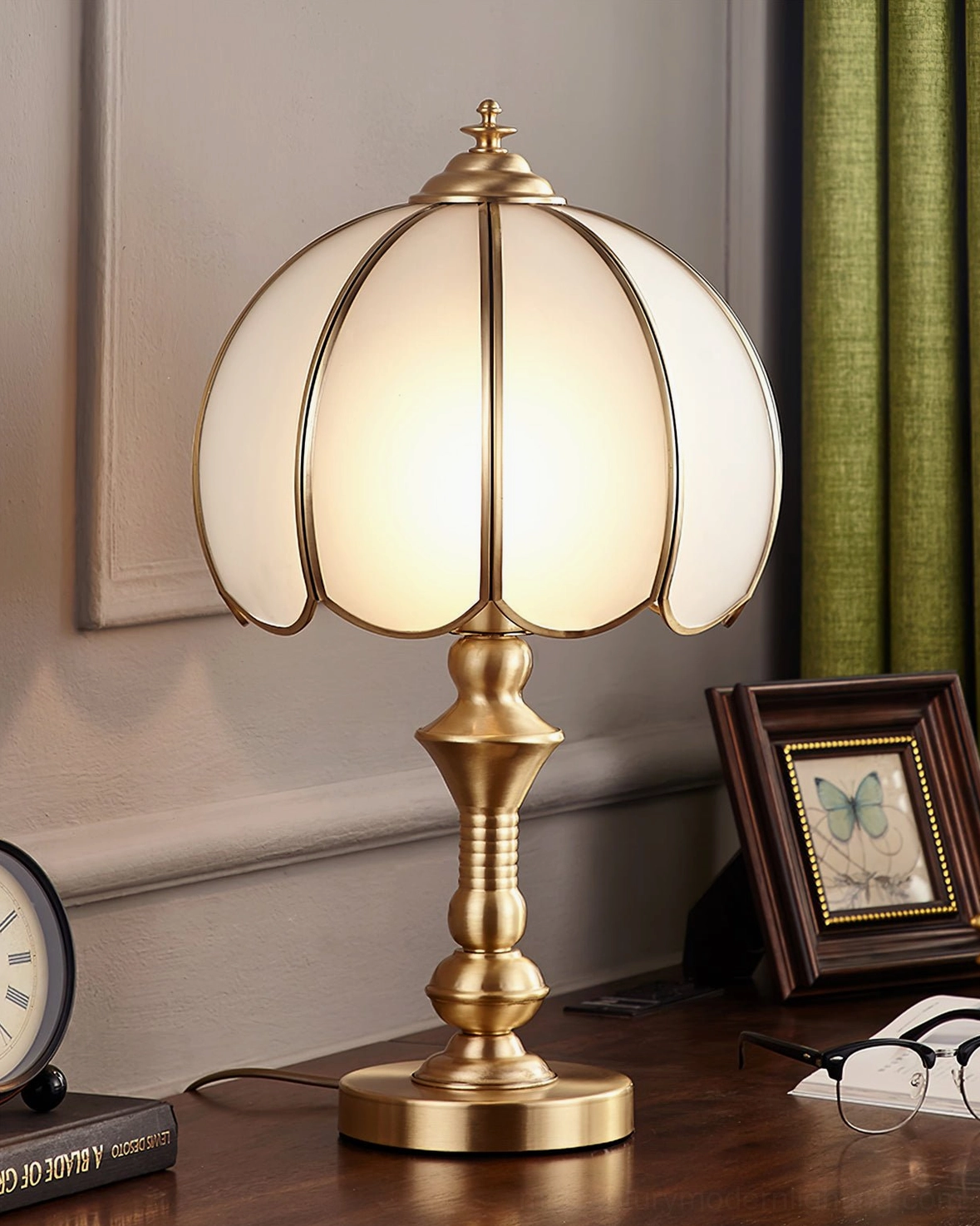 Vintage brass table lamp with frosted white glass creating warm intimate lighting in living space