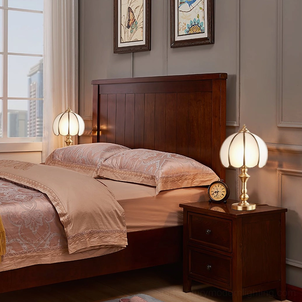 Brass table lamp three-quarter view showing petal-shaped glass shade and solid brass construction
