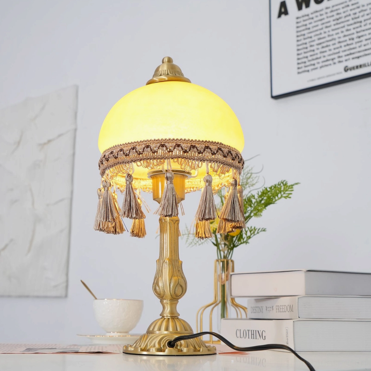 Vintage brass table lamp with warm lighting on dining table with wall art and green plant