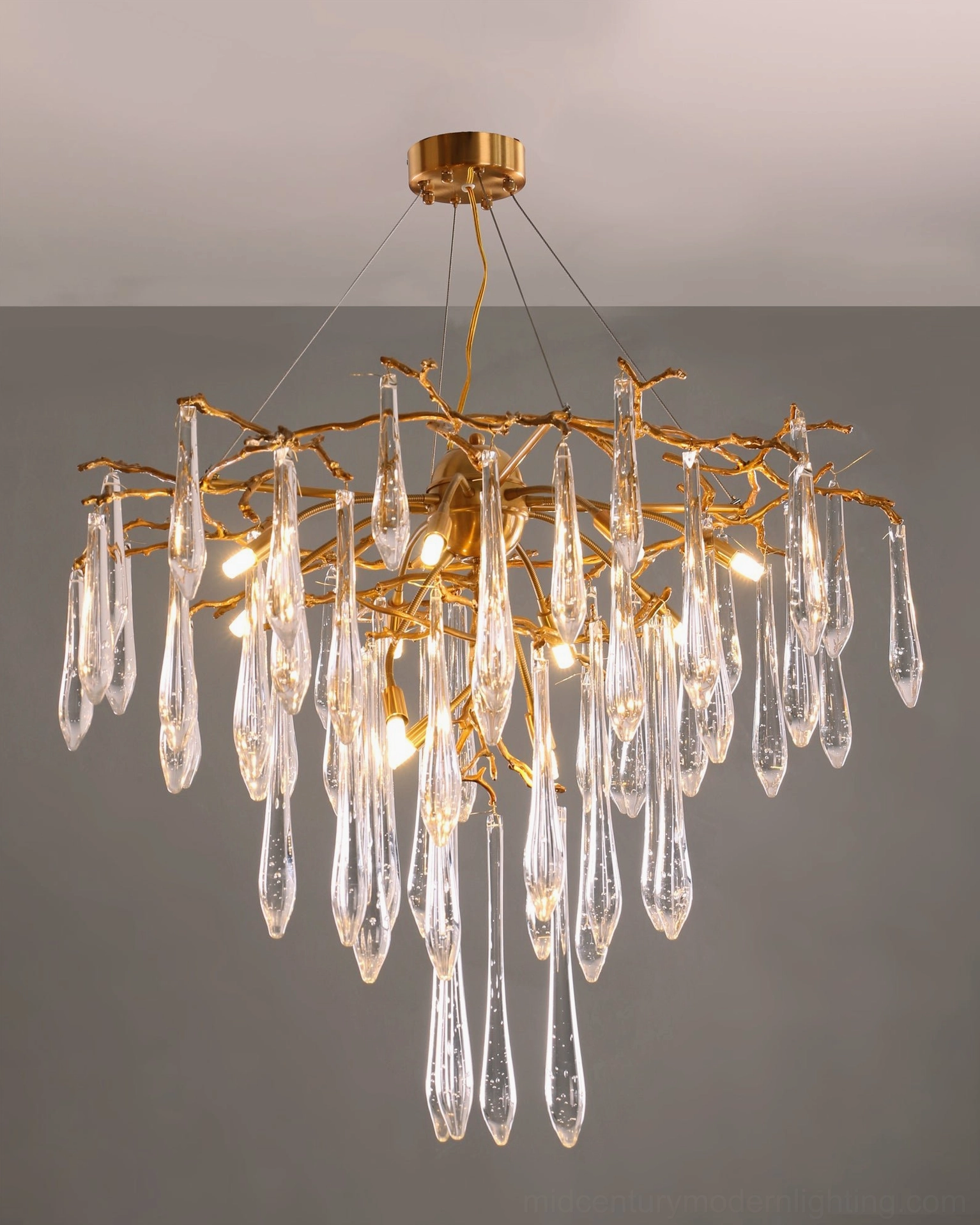Brass teardrop crystal chandelier high ceiling installation dramatic drop double-height space