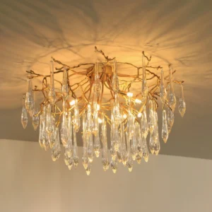 Overhead view of brass teardrop pendant lamp showing crystal droplet details and warm golden light
