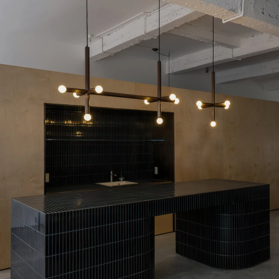 Industrial style dual brass cross pendant lamps in commercial kitchen setting