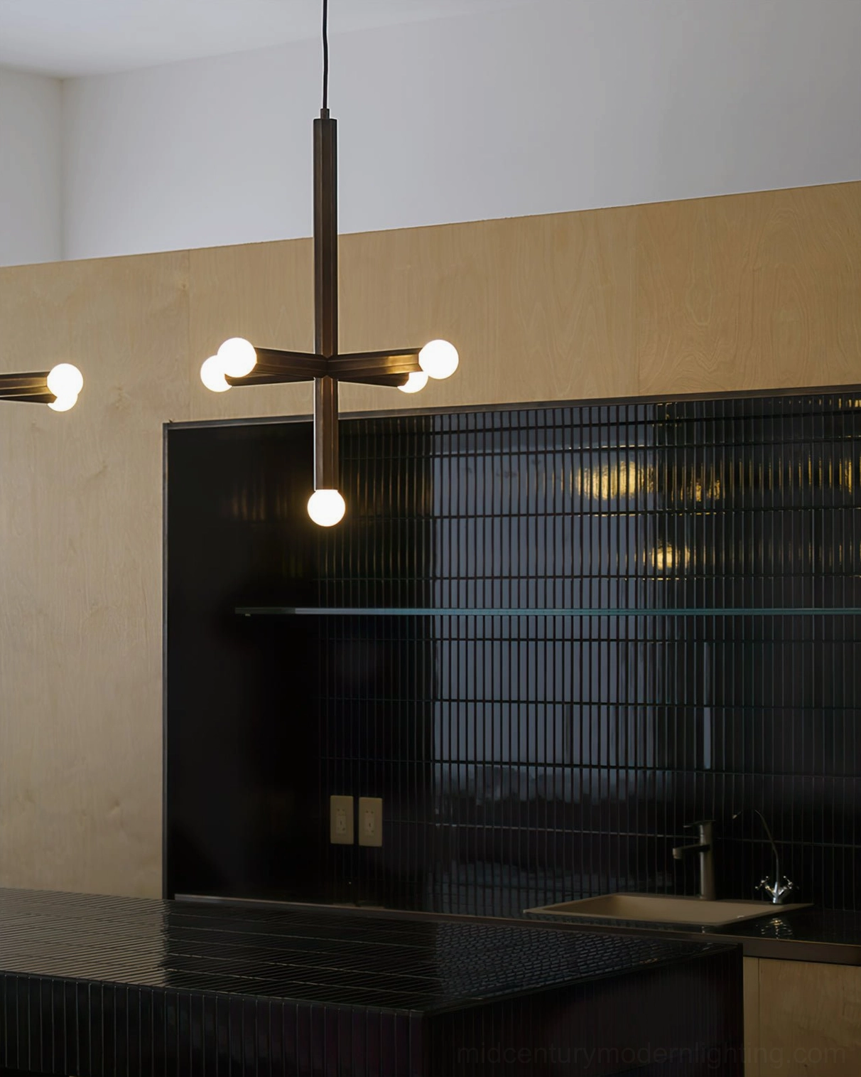 Single head aged brass pendant light over modern kitchen counter workspace