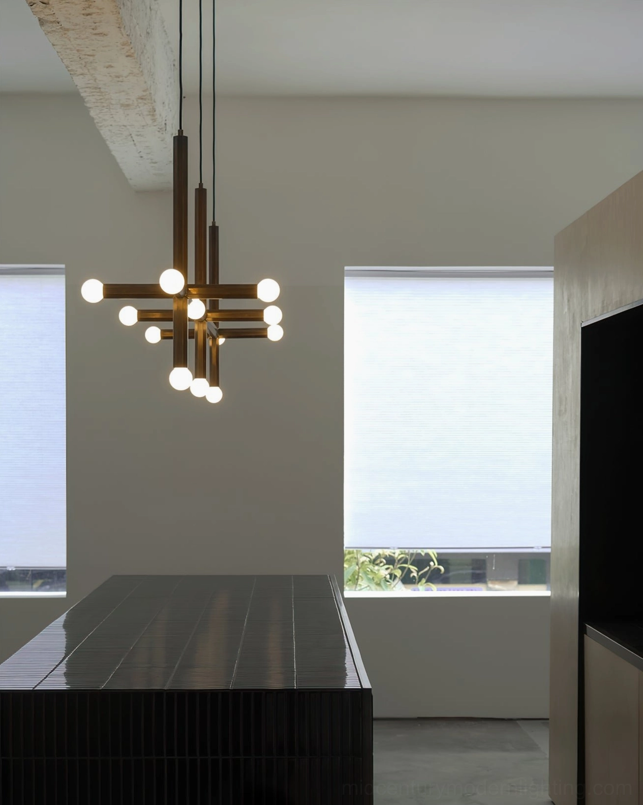 Clustered brass pendant lamps in minimalist bright kitchen with natural light