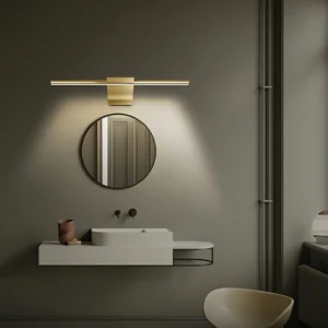 Minimalist bathroom vanity with brass wall lamp mounted above round mirror