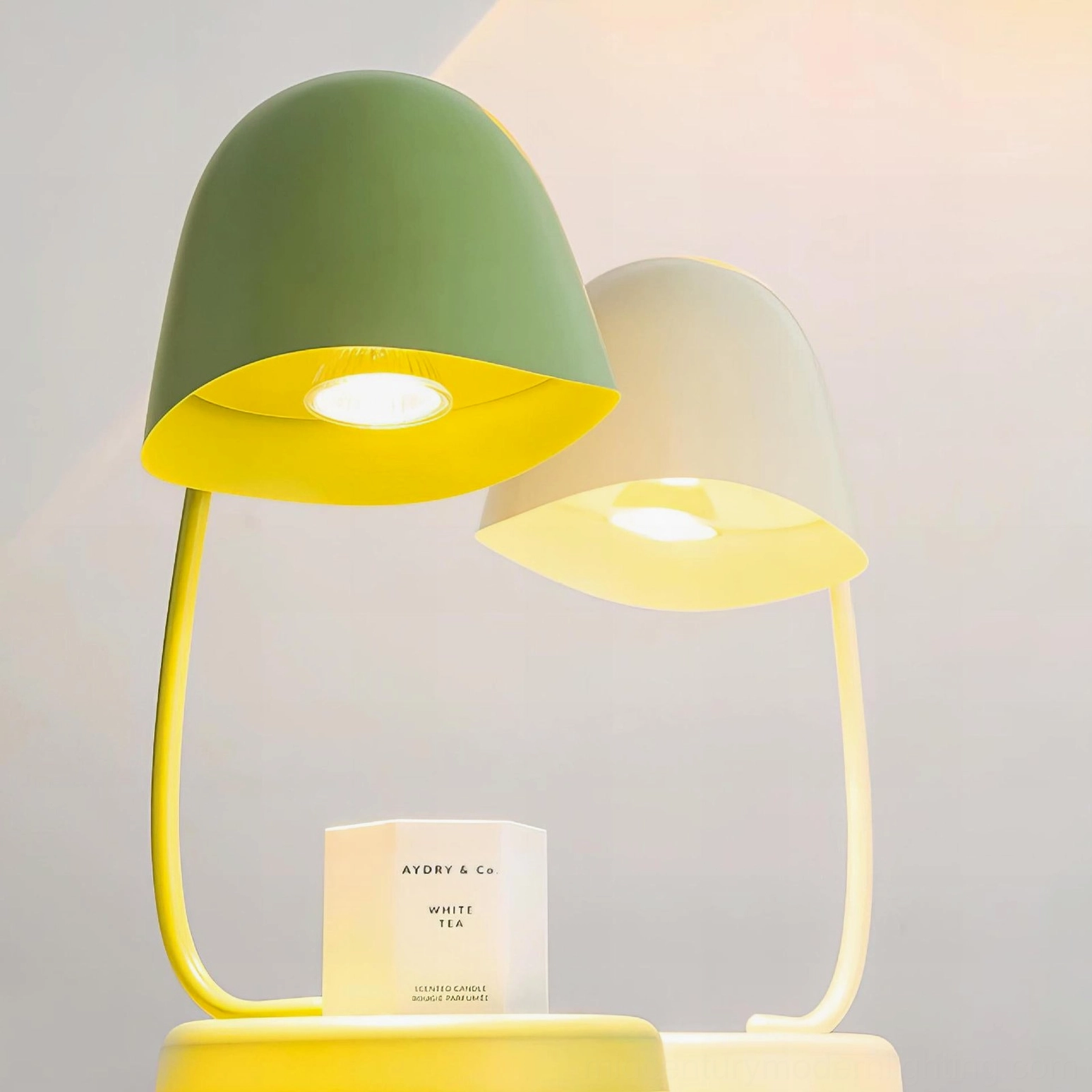 Close-up of Breez candle lamp showing warm yellow LED light through metal reflector shade design detail