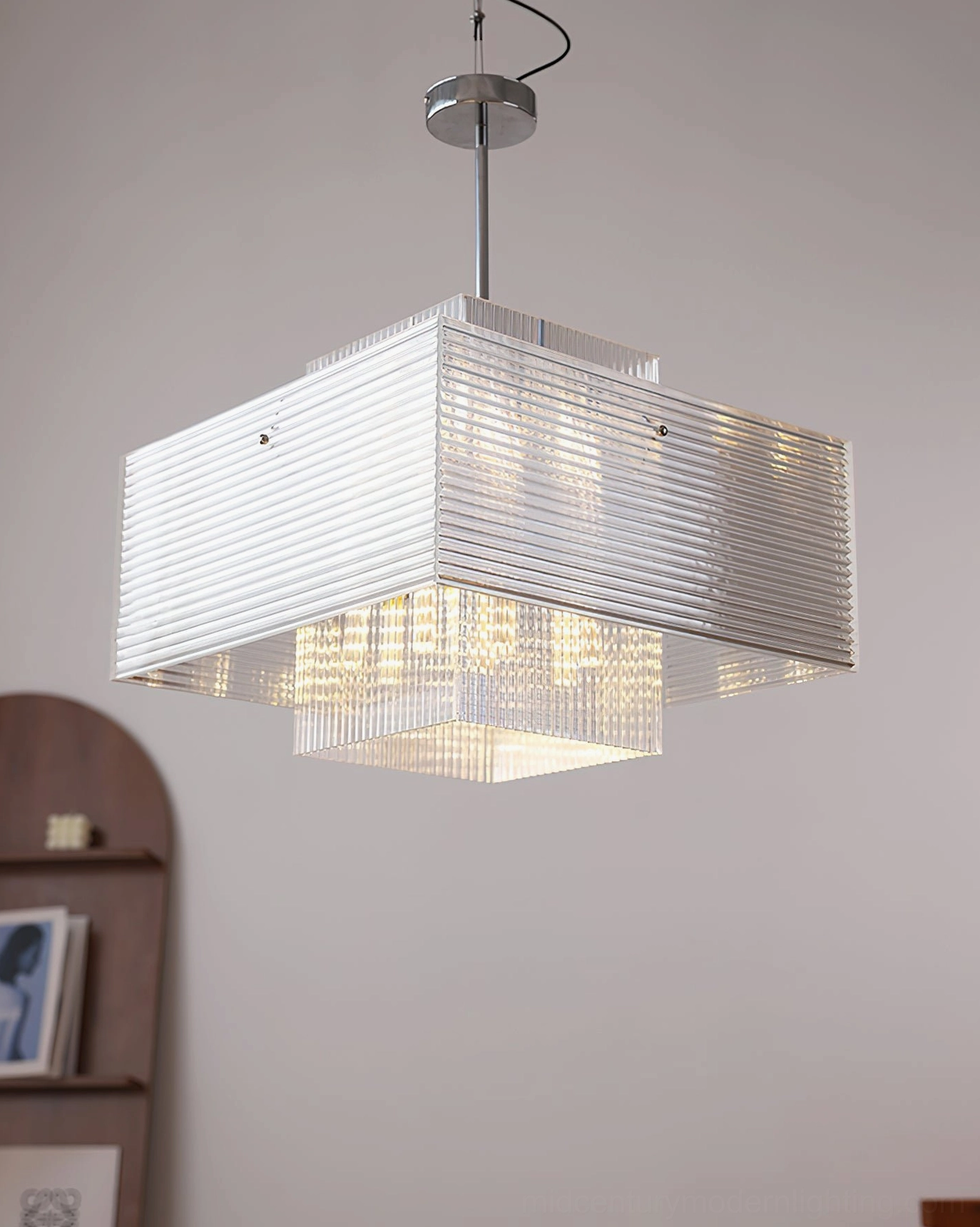 Bottom overhead view of Brenna layered glass pendant with glowing warm light and chrome top mount