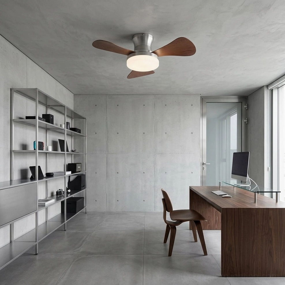 Brennan low-profile ceiling fan light in minimalist home office with exposed concrete walls and metal shelving