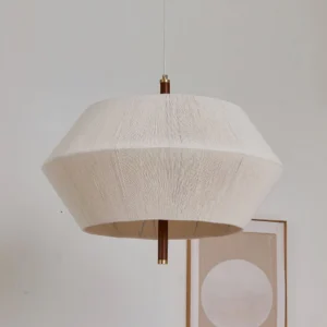 Brera pendant light showing beige woven hemp shade with dark wood drop rod mounted to ceiling, mid-century modern interior design