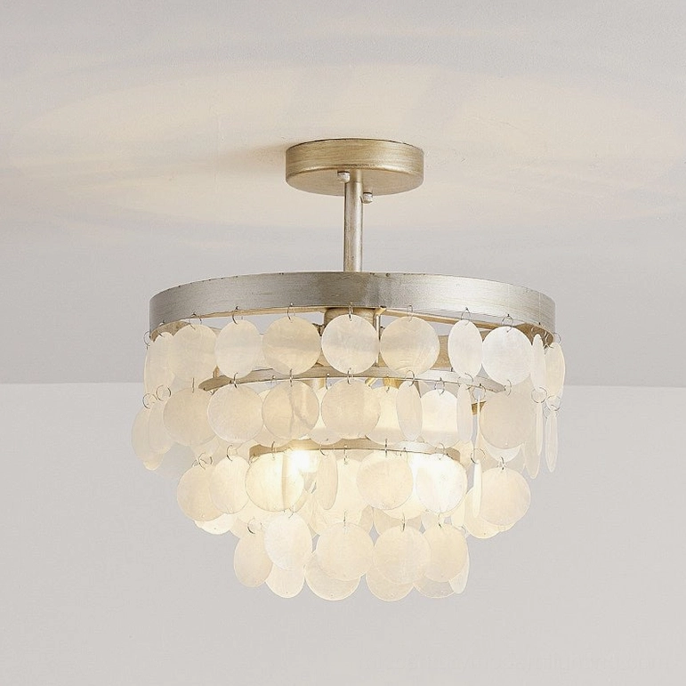 Brielle ceiling lamp glowing upward angle with warm light through layered capiz shell shade