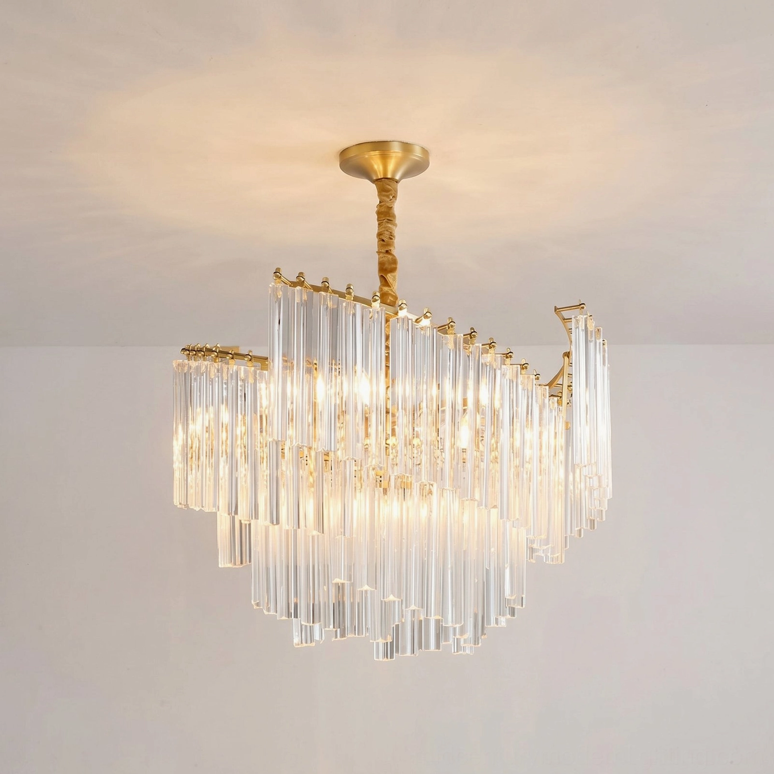 Brinicle tiered crystal chandelier demonstrating warm glow and crystal sparkle effect