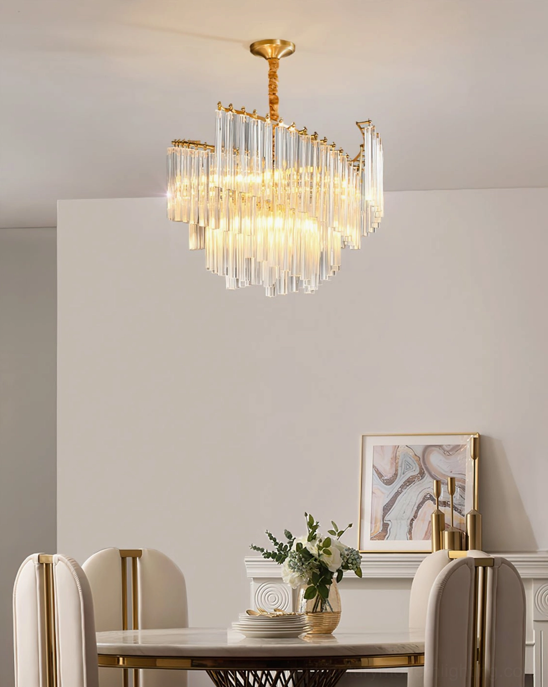 Small Brinicle tiered crystal chandelier in minimalist modern dining area with neutral decor
