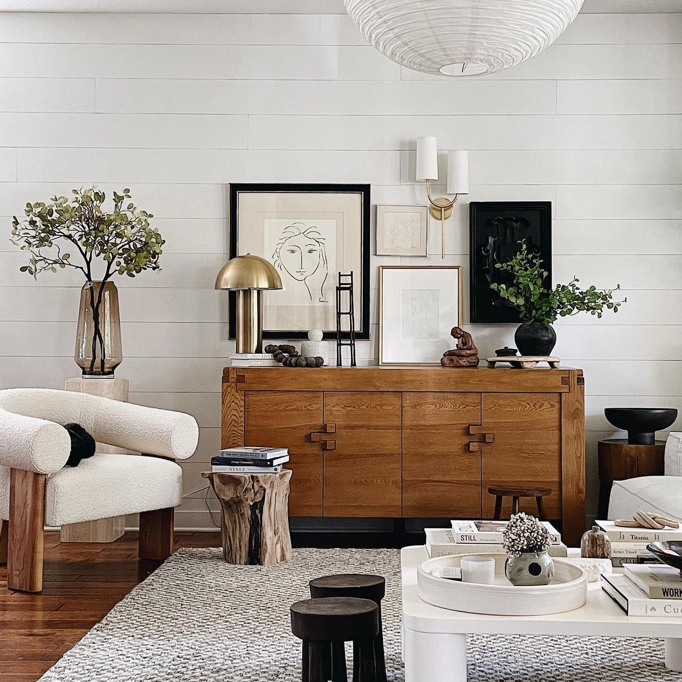Brio brass wall sconce in modern farmhouse living room with wooden furniture and warm decor styling