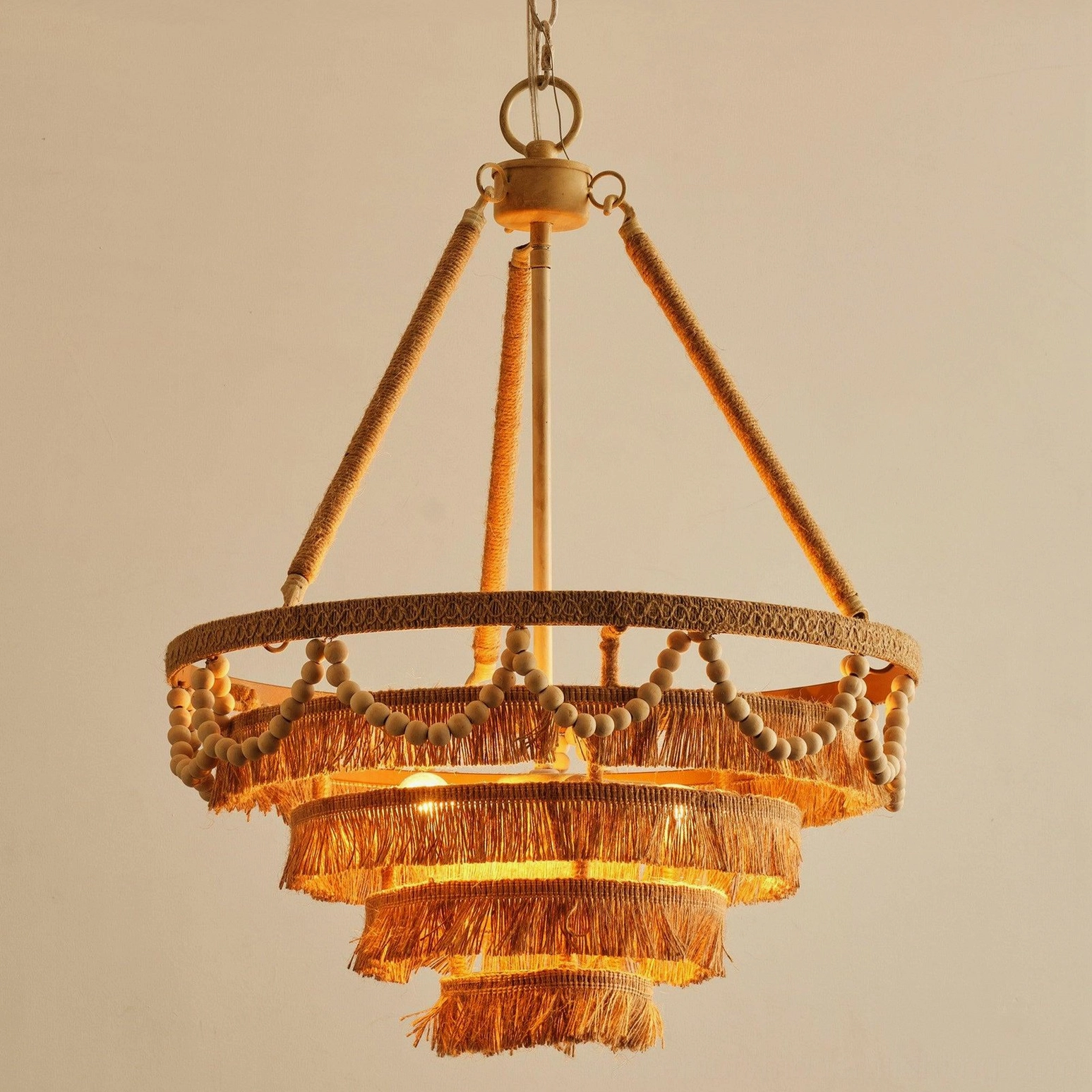 Bristol chandelier artistic angle revealing wooden bead placement and layered raffia fringe composition