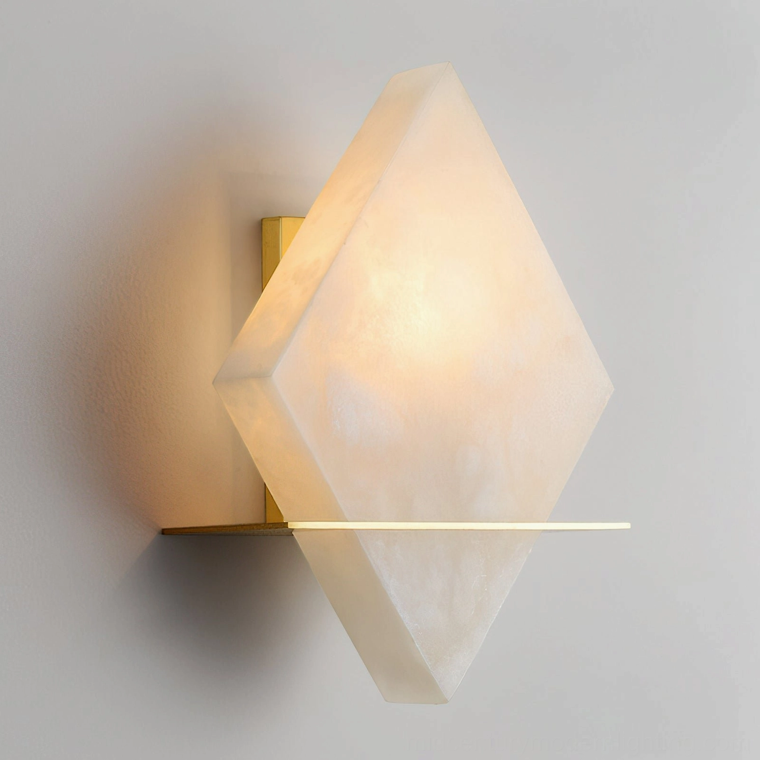 Brockton Alabaster Wall Lamp illuminated side view, warm light glowing through translucent alabaster stone