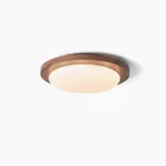 Bromo walnut flush mount ceiling light with frosted glass dome, studio overhead view showing wood-framed design
