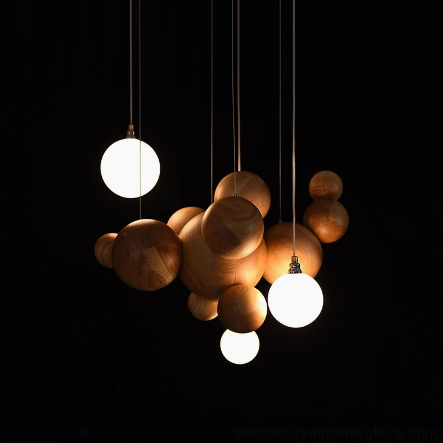 Sculptural wood ball chandelier with warm LED glow against black backdrop, emphasizing organic sphere design