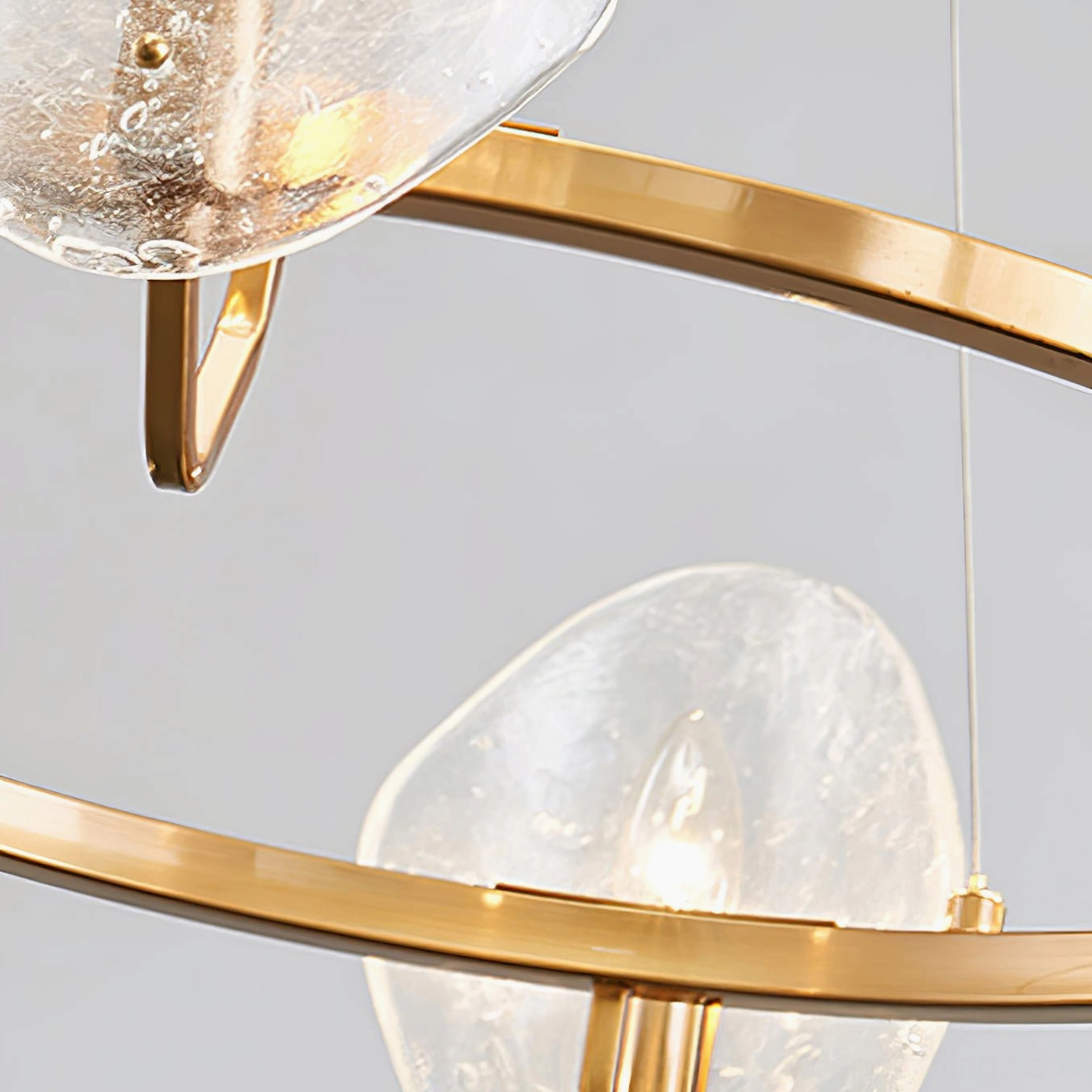 Close-up detail of bubble glass shades and brass gold metal frame structure