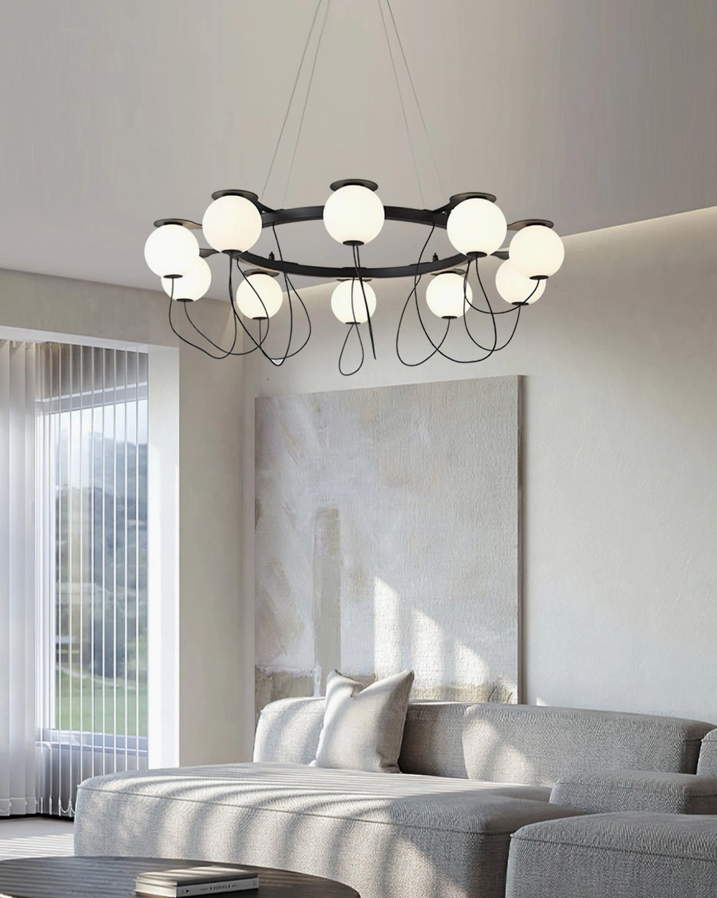 Sculptural bubble pendant fixture with multiple frosted glass orbs creating ambient lighting over gray sofa