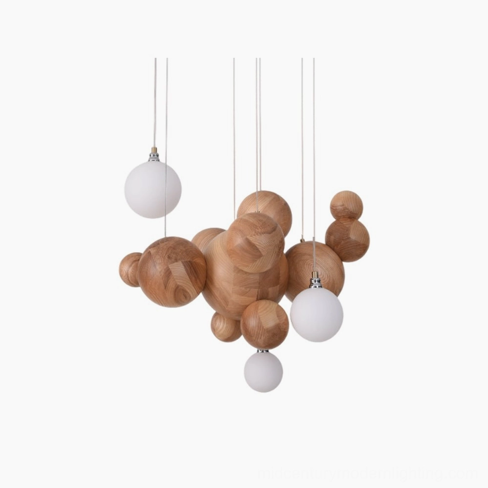 Bubble wood sphere chandelier with natural light wood finish suspended from ceiling, displaying frosted glass diffusers in minimalist studio setting