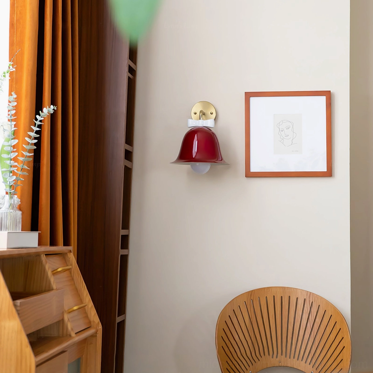 Burgundy Bow Bell Wall Lamp above wooden chair and framed art in minimalist vintage study corner