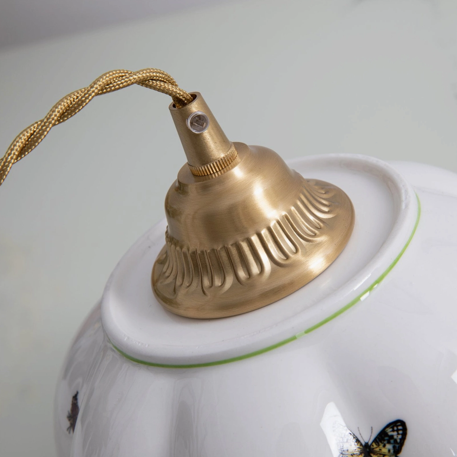 Detailed close-up of ceramic butterfly pendant lamp showcasing artistic butterfly detailing and glaze finish