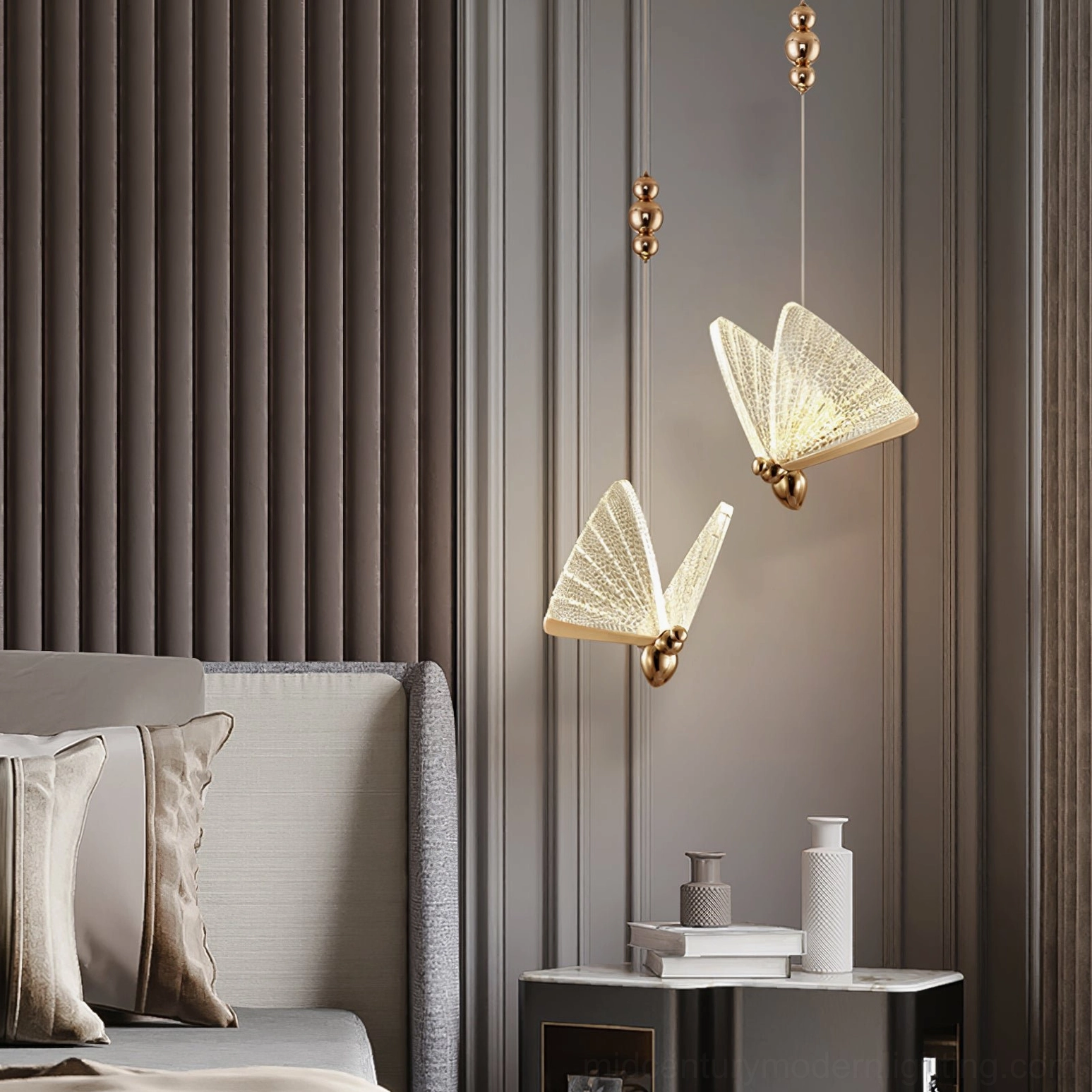 Multiple butterfly pendant lights installed in modern bedroom with warm glow and striped accent wall