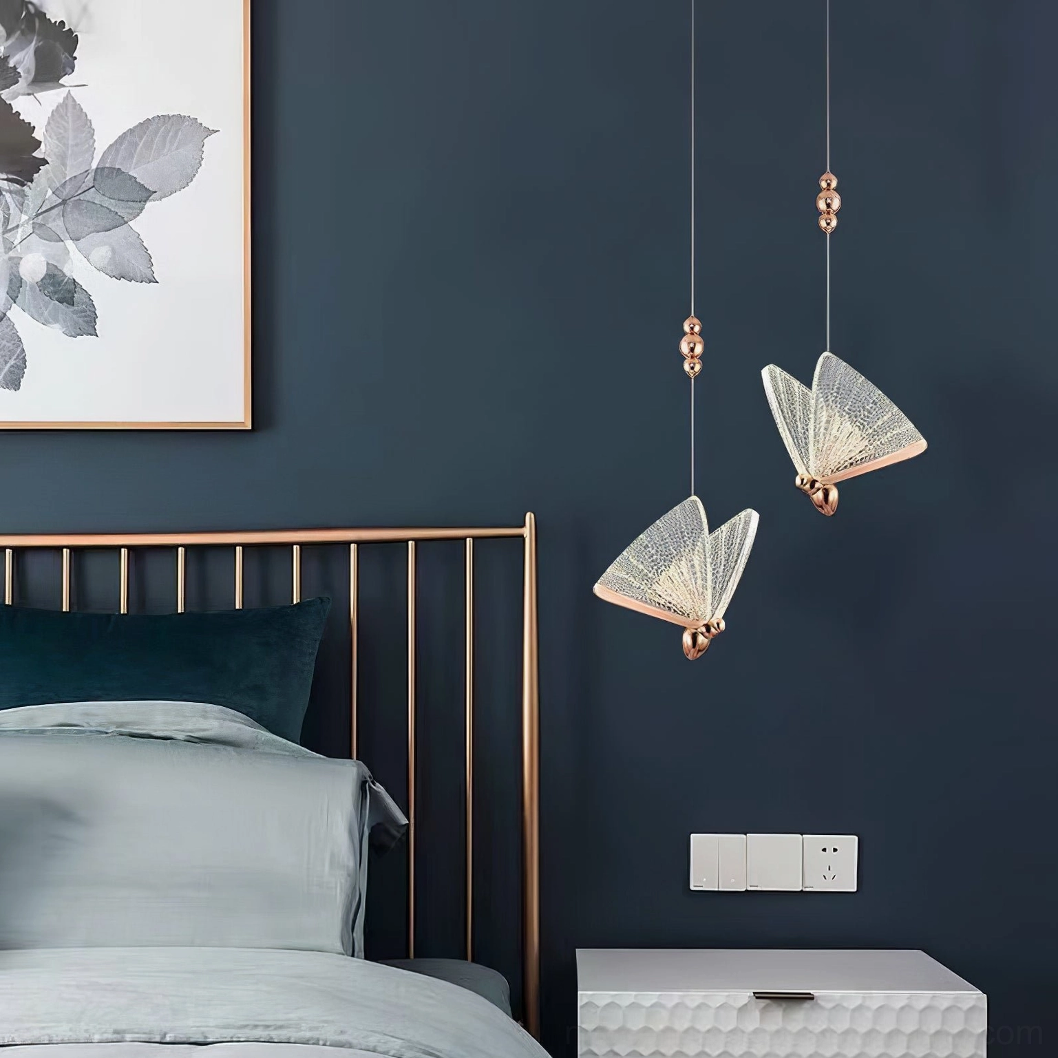 Dual butterfly pendant lights with rose gold hardware in dark blue bedroom