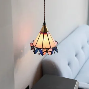 Illuminated butterfly Tiffany glass pendant casting warm light in modern living room setting