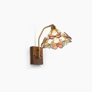 Lulla butterfly Tiffany wall lamp with pink stained glass butterflies and brass swing arm mounted on white background