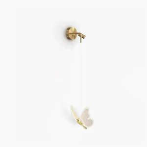 Modern butterfly LED wall lamp with illuminated acrylic shade and brass gold hardware on white background
