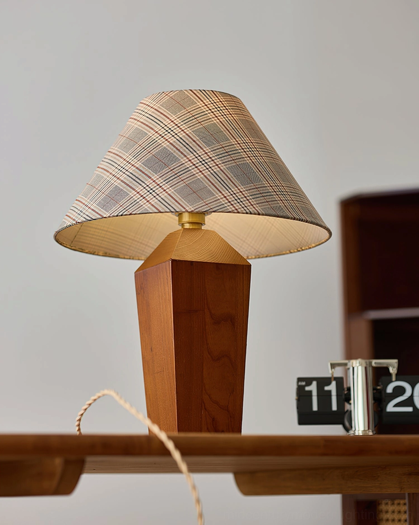 Cabin table lamp side profile with brass metal hardware and twisted fabric power cord on wooden desk