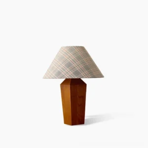Cabin mid-century modern table lamp with walnut wood geometric base and red plaid fabric shade, front studio view