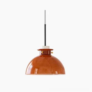 Cabras mid-century pendant light with caramel glass dome and brushed gold brass hardware, studio front view on white background