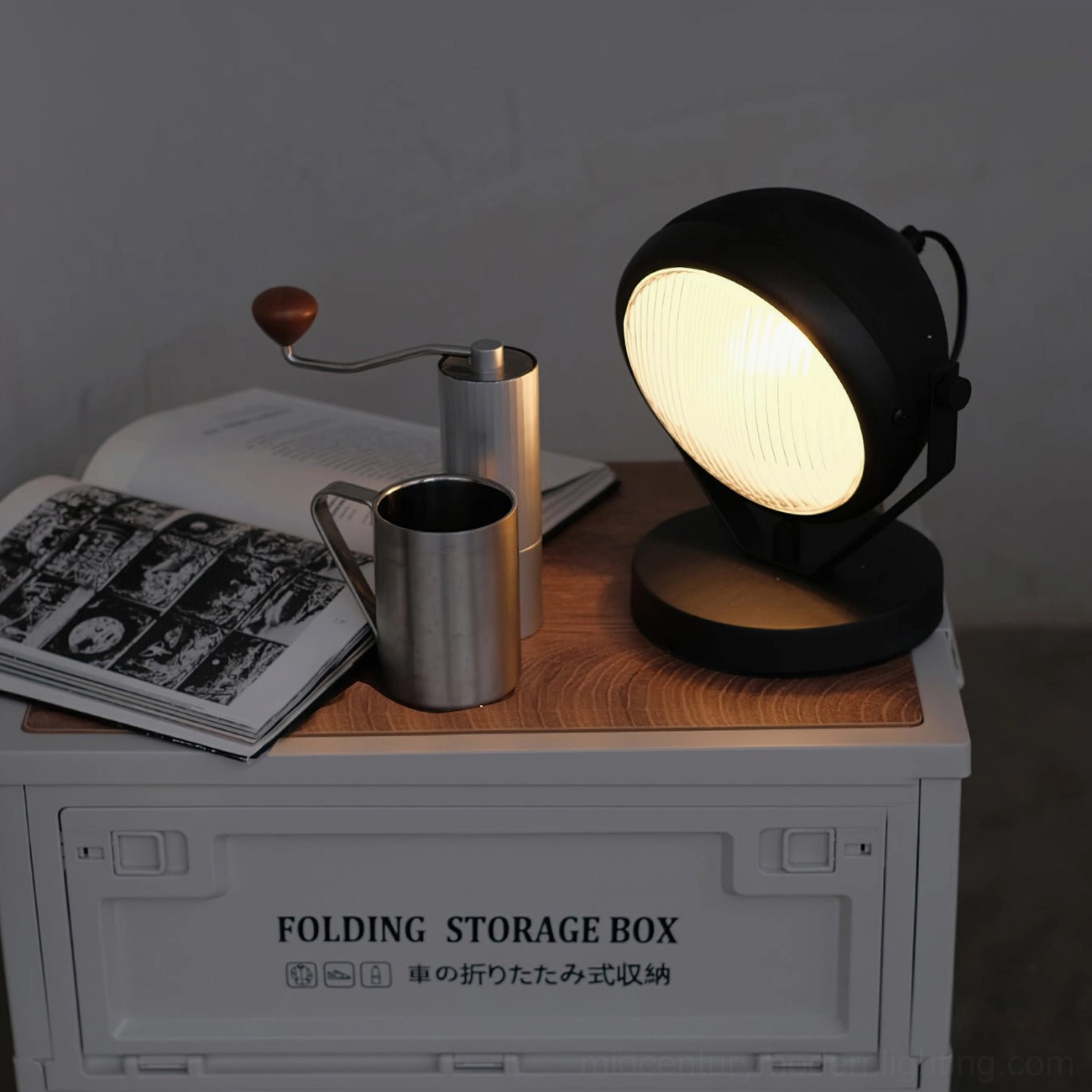 Cadillac matte black industrial table lamp full view on storage furniture with coffee accessories and magazines