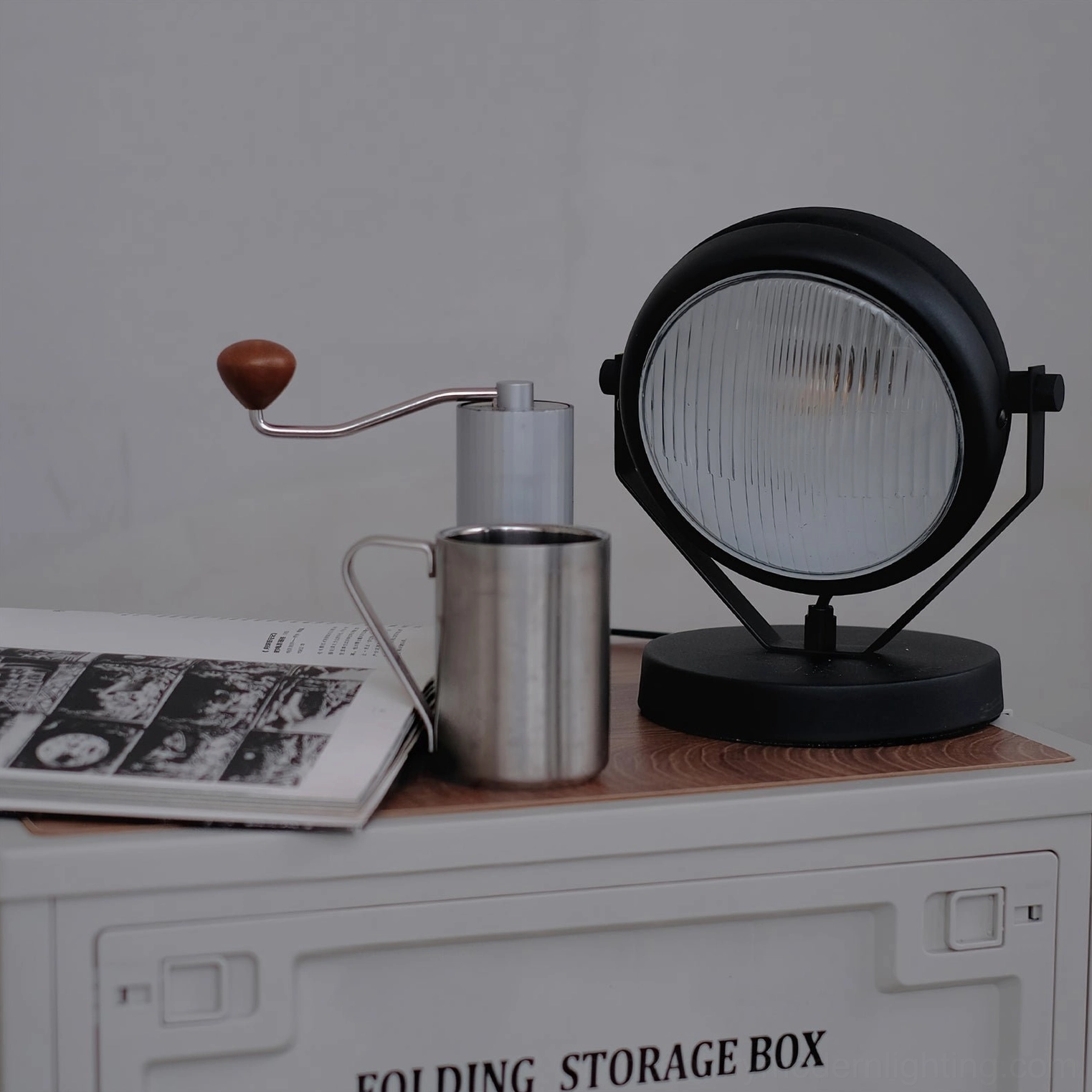 Cadillac matte black industrial spotlight table lamp on storage box side table with vintage coffee grinder and styling