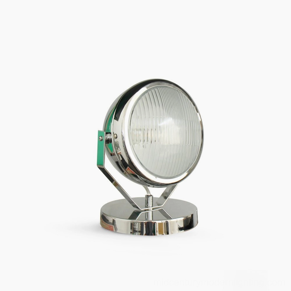 Cadillac industrial spotlight table lamp with polished chrome finish - front studio view showing round reflective headlight-inspired design