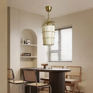 Mid-century modern caged chandelier installed in cream dining room with rattan chairs and dark wooden table