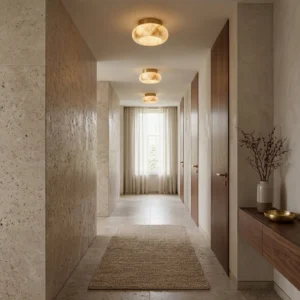 Lit Cairns alabaster ceiling lamp illuminating hallway with warm ambient glow, modern minimalist residential interior