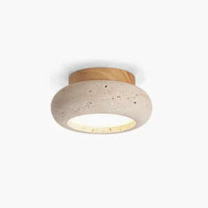 Cairns travertine ceiling light on white background showing sculptural stone disc with warm wood base