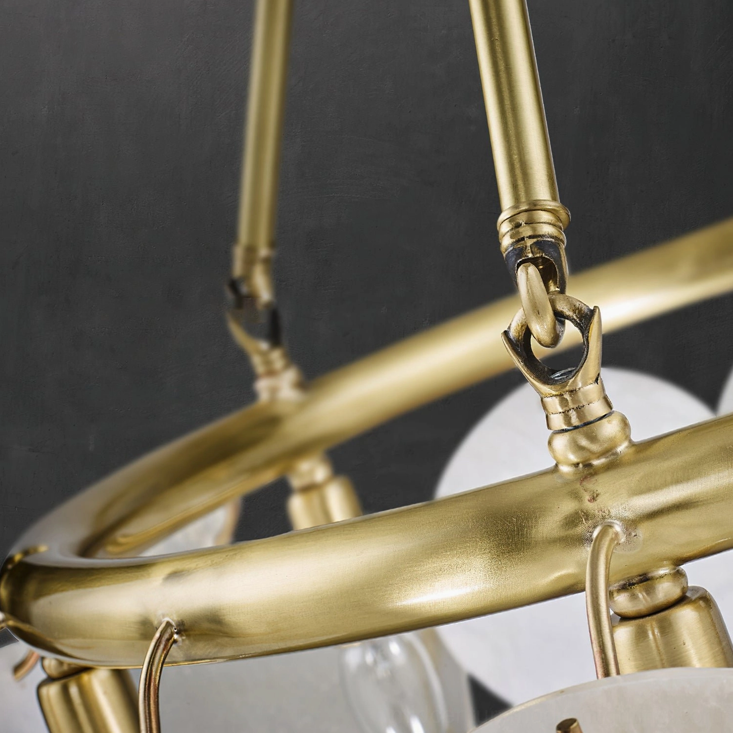 Calamete chandelier polished brass hardware joint, metal frame closeup, hand-finished brass mid-century structure