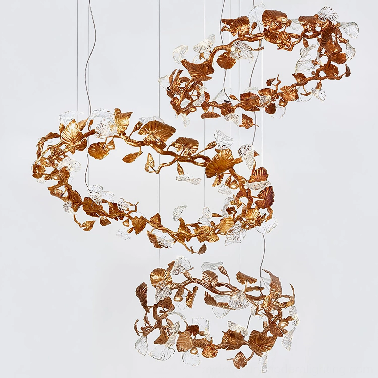 Overhead view of spiral double-layer Calathea chandelier with cascading brass and clear glass leaf decorations, showcasing layered design